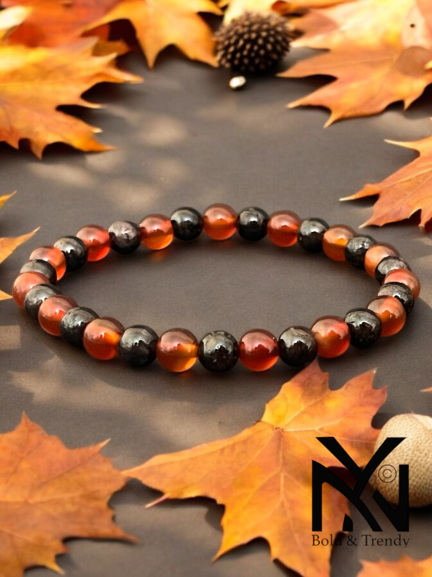 Flamme d'Automne bracelet with fiery red and amber gemstones, symbolizing transformation and strength