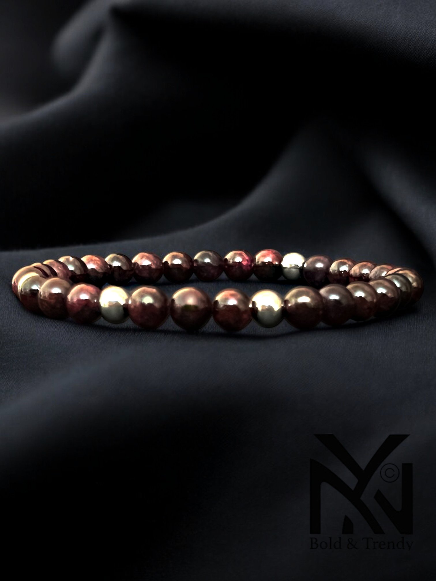 Forêt Enchantée bracelet featuring rich garnet stones in earthy tones, evoking a sense of enchantment and strength